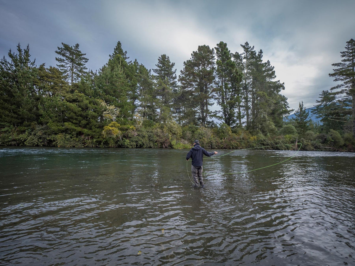 Angler casting heavy bomb flies on the Tongariro River, New Zealand